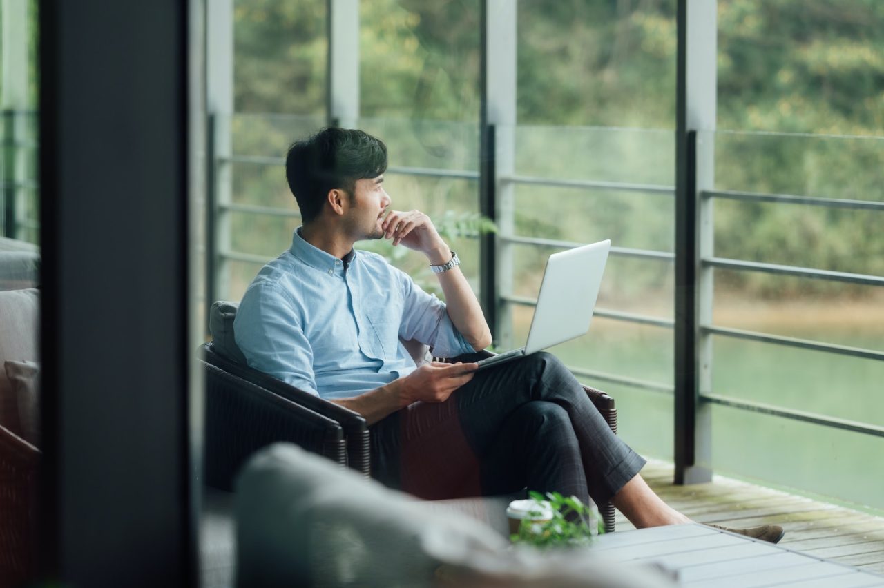 asian-businessman-using-laptop-at-office-window.jpg